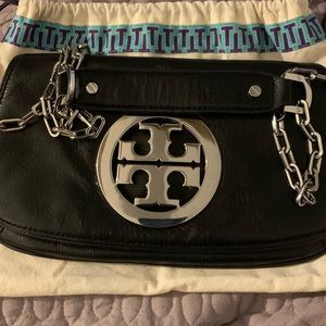 Black Tory Burch clutch with strap.